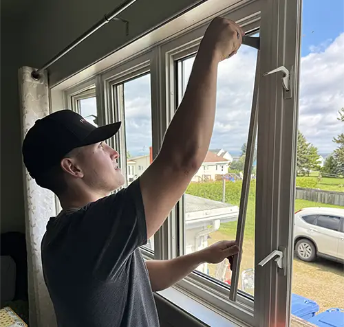Technician replacing a window glass unit